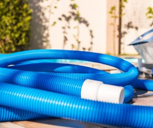 Blue plastic hose for cleaning a swimming pool, Yesulskaya, Krasnodar, Russia. Close-up